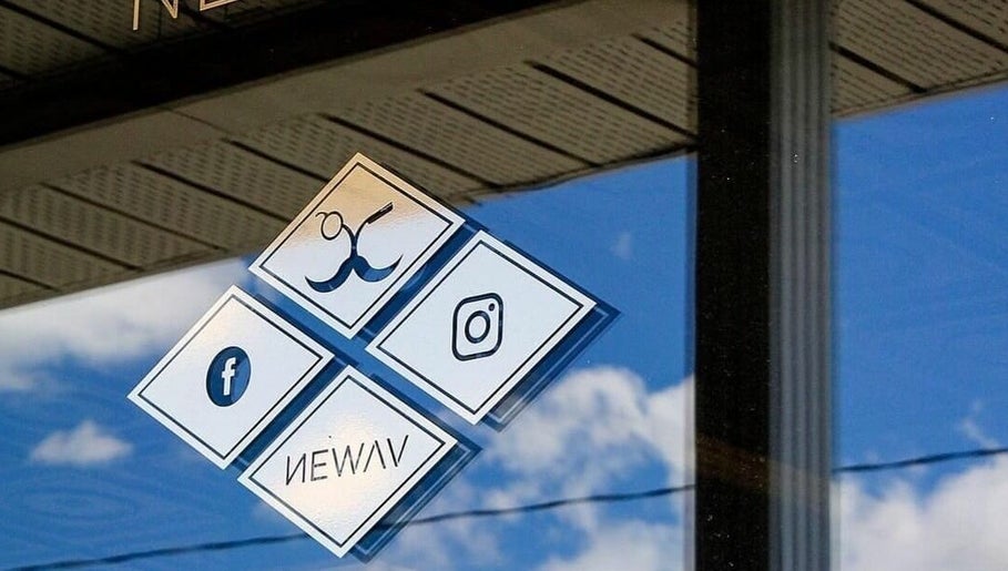 Social media icons on Newav Saint-Rémi's window, Saint-Rémi, Quebec, CA reflecting the sky.
