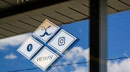Social media icons on Newav Saint-Rémi's window, Saint-Rémi, Quebec, CA reflecting the sky.