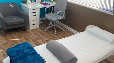 Therapy room at Michelle Denise Craniosacral Therapy Somerton in Somerton, England, GB with treatment bed and desk.