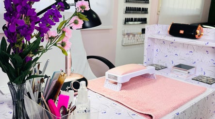 Elegant Touch By Lia's Nails manicure setup with pink mat and flowers in Willemstad, Curaçao, CW.