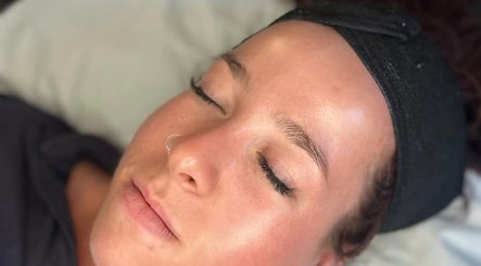 Relaxed client with glowing skin at Queen Bee Beauty Enhancement, Donington, England, GB.