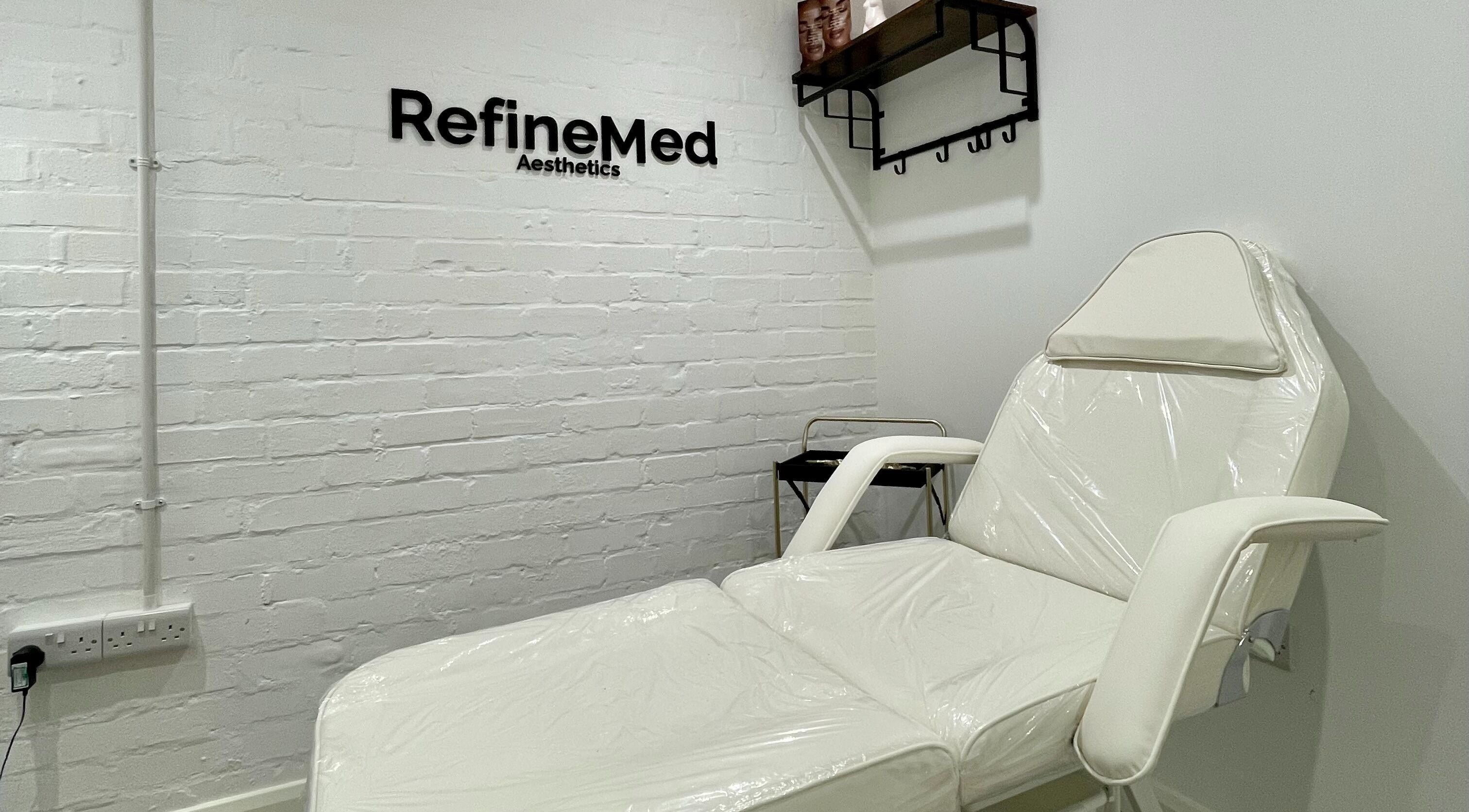RefineMed Aesthetics treatment room in Newcastle upon Tyne, England, GB featuring modern white furniture.
