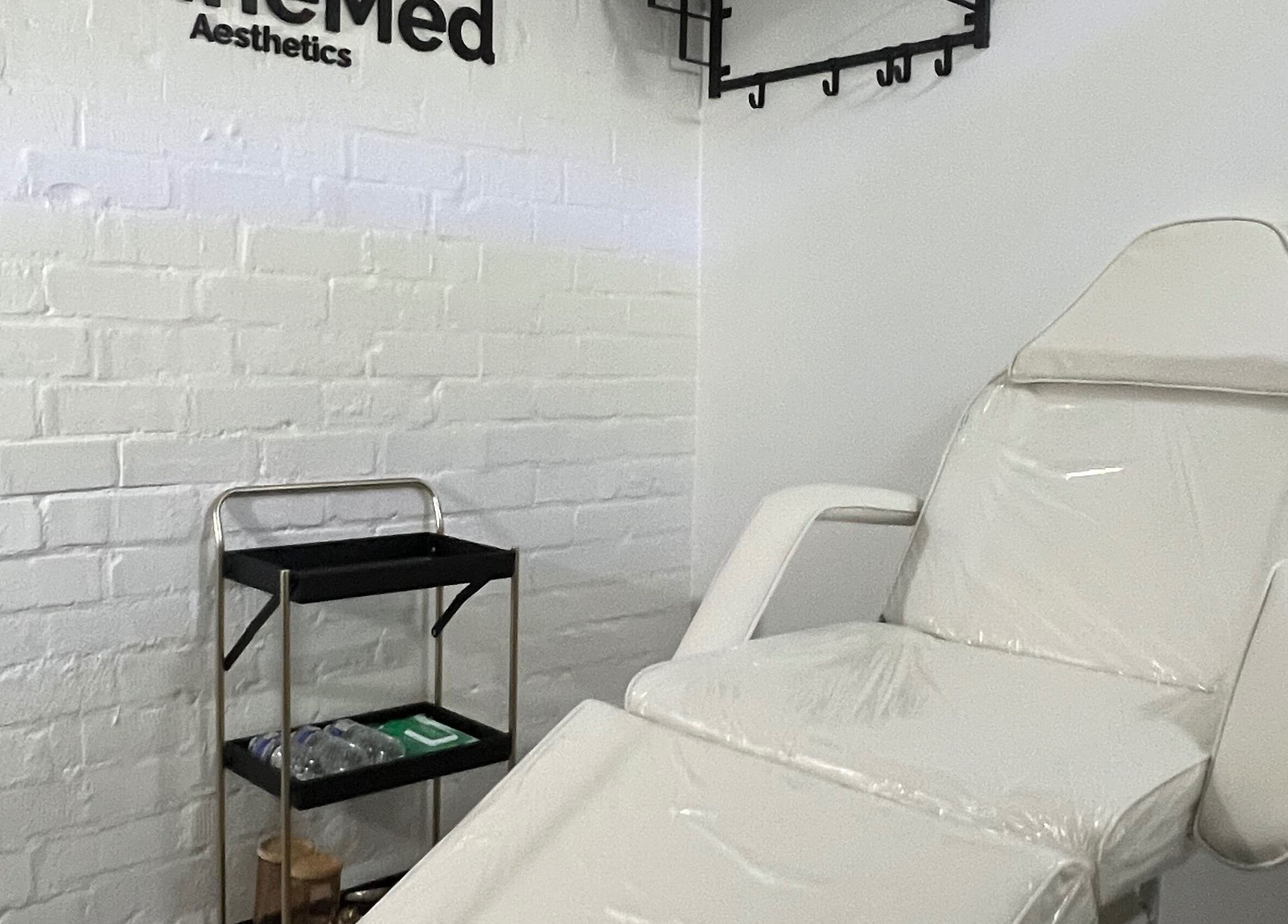 Treatment room at RefineMed Aesthetics in Newcastle upon Tyne, England, featuring a comfortable white chair.