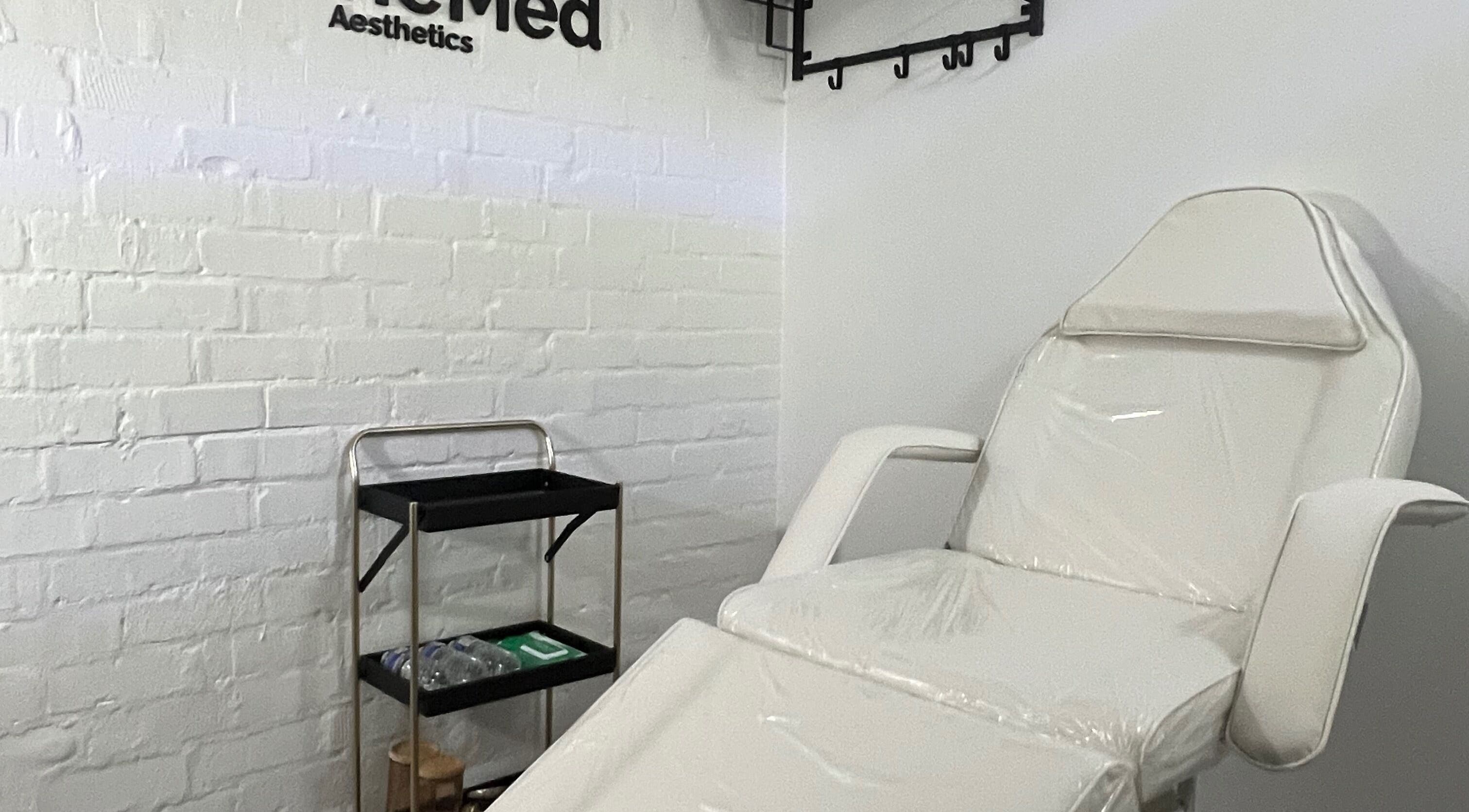 Treatment room at RefineMed Aesthetics in Newcastle upon Tyne, England, featuring a comfortable white chair.