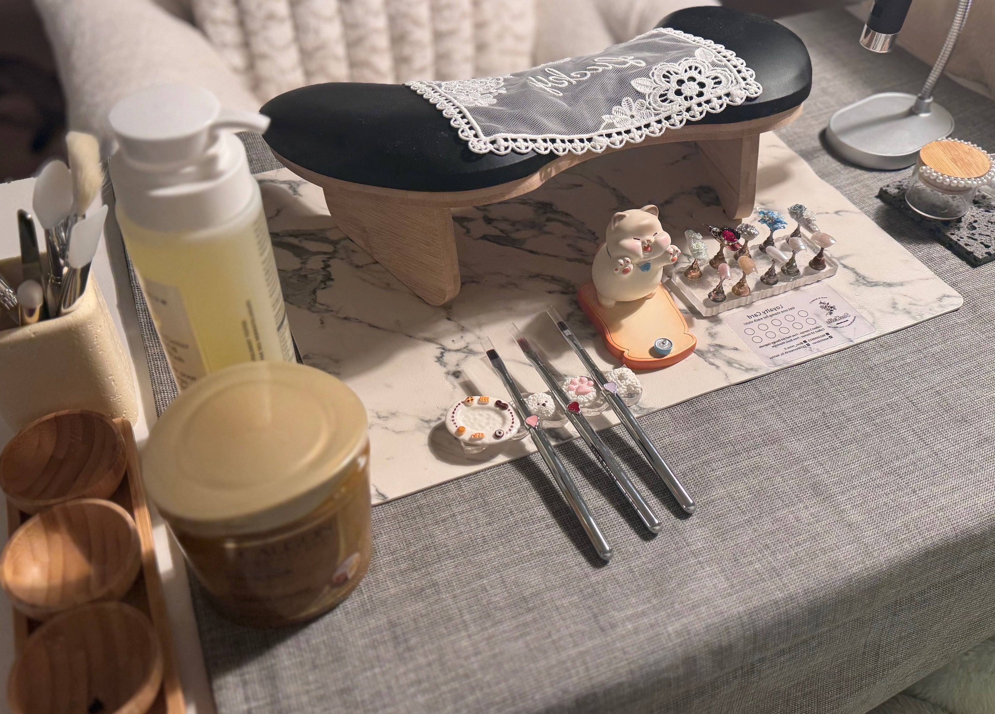 Nail art tools and products displayed at JasNail Studio, Halifax, Nova Scotia, CA. Cozy nail station ambiance.