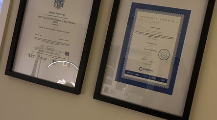 Framed certificates at The Retreat at Salon Nine, Stone, England, GB showcasing spa and massage qualifications.