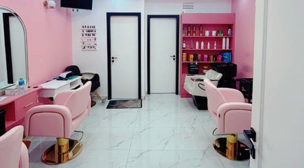 Stylish interior of Flicks Glam Ladies Salon in Dubai, AE with elegant pink chairs and modern decor.