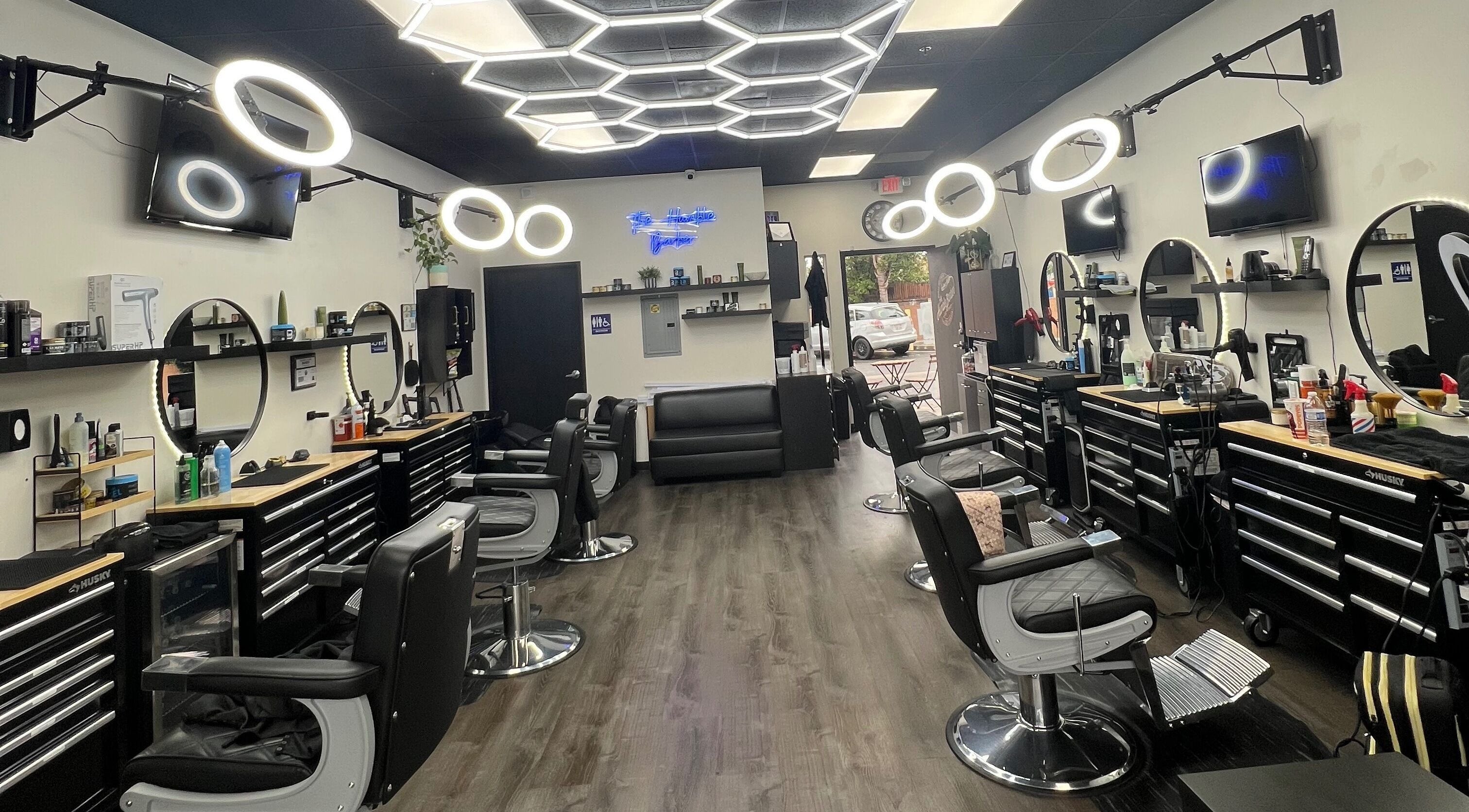 Modern interior of The Humble Barber in Los Angeles, California, US, featuring stylish chairs and lighting.