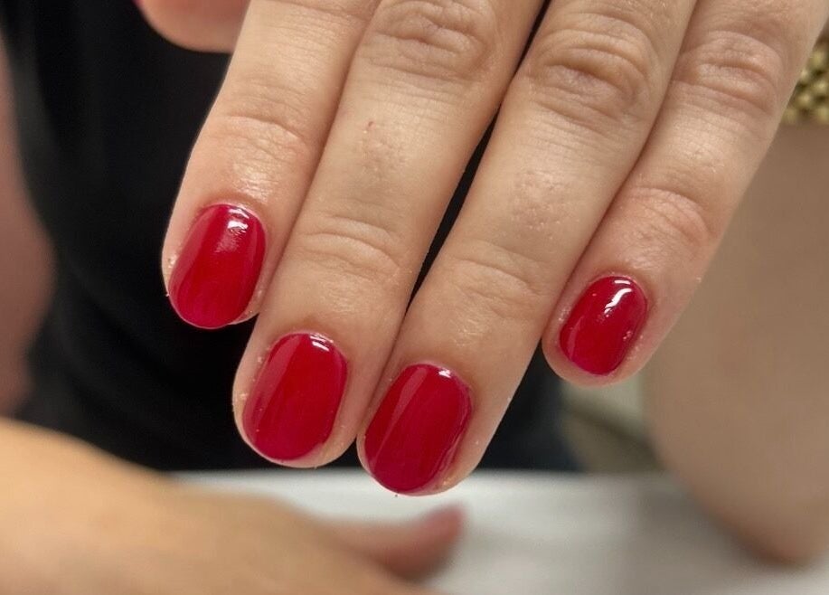 Vibrant red manicure at Chloe at No. Eleven, Great Yarmouth, England, GB, showcasing nail artistry.