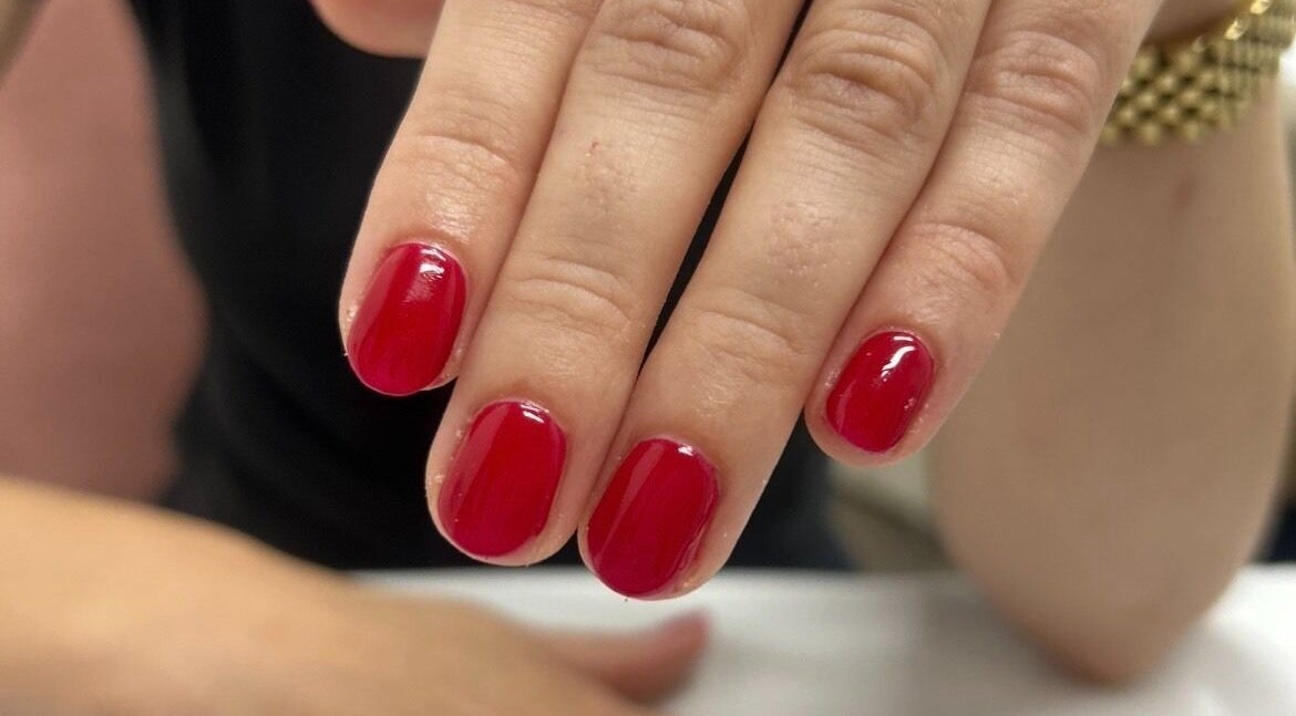 Vibrant red manicure at Chloe at No. Eleven, Great Yarmouth, England, GB, showcasing nail artistry.