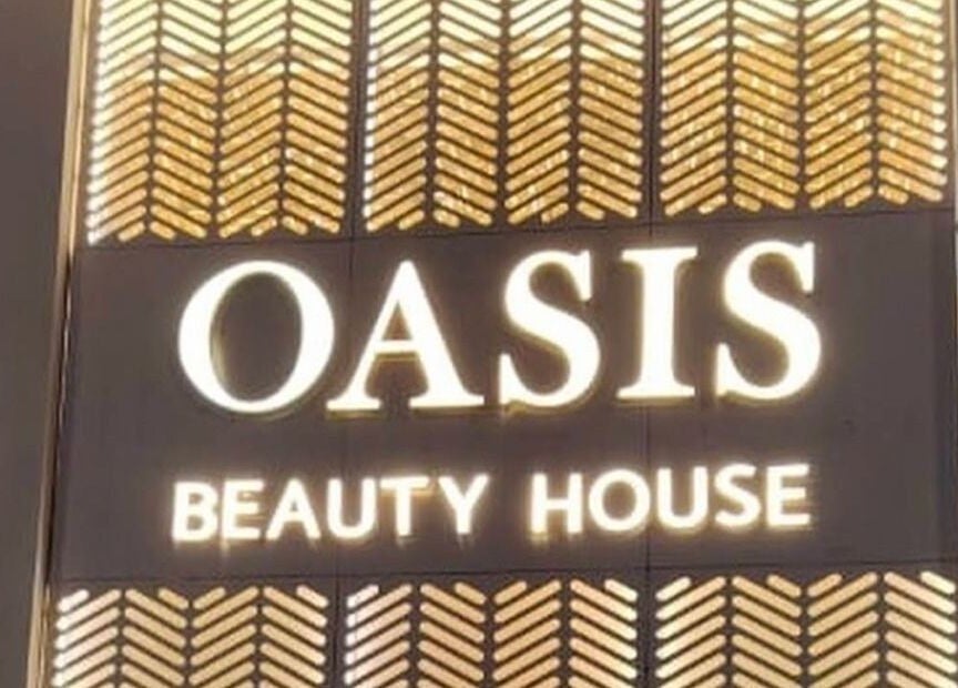 Illuminated sign of OASIS BEAUTY HOUSE at Riyadh, Riyadh Province, SA, showcasing opulent design.