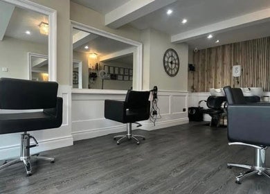 Chic interior of Amt Hair & Extensions in Ballymena, Northern Ireland, GB, featuring modern styling chairs.