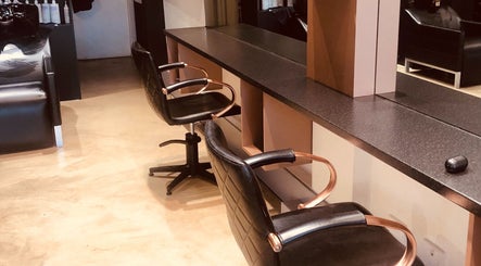 Elegant salon chairs at Lotus Hair Salon, Camberwell, Victoria, AU with sleek styling stations.