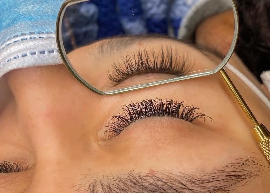 Close-up of a client's enhanced eyelashes at GuchiGlowUp in Eugene, Oregon, US showcasing meticulous detail.