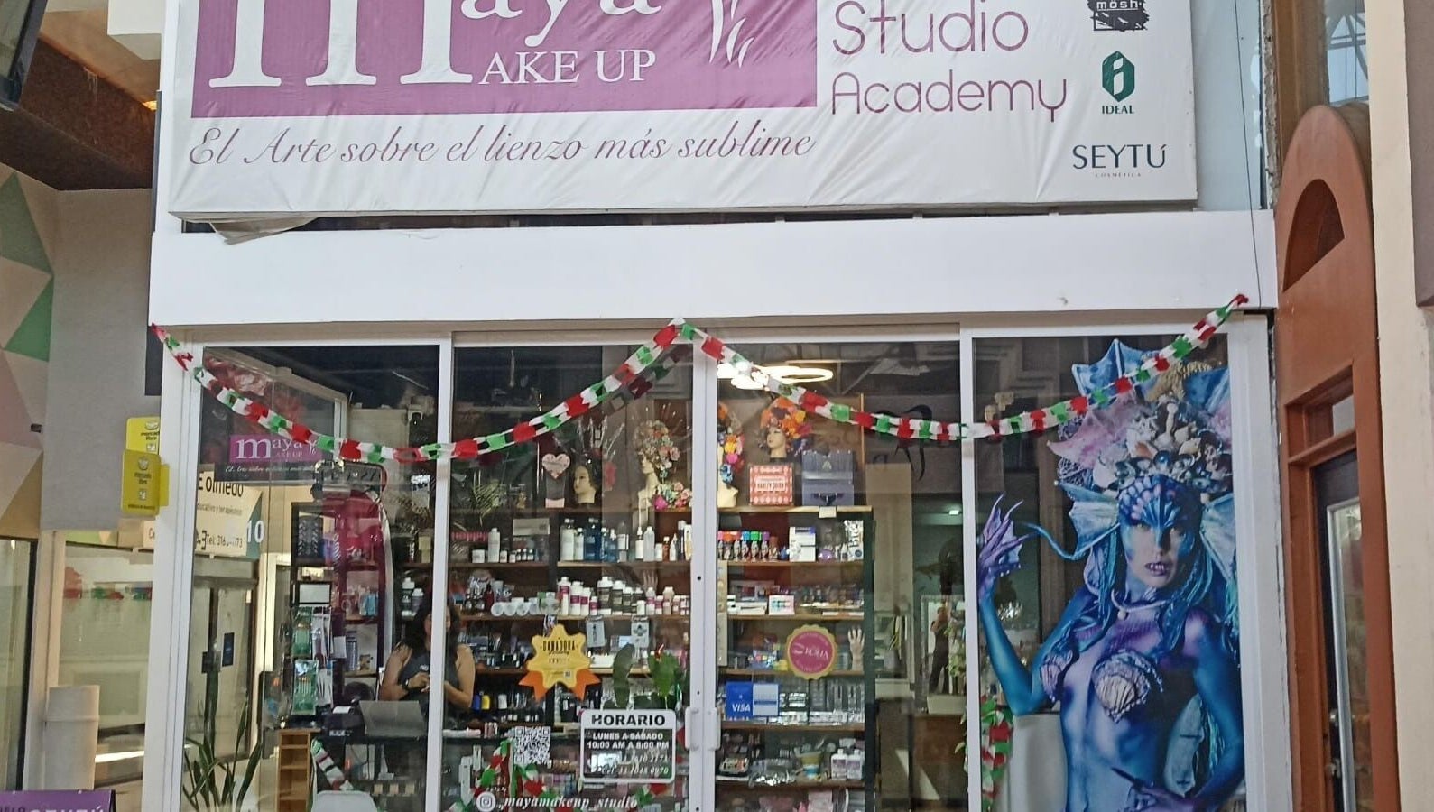 Entrance of Maya Make Up in Zapopan, Jalisco, MX, showcasing beauty products and festive decor.