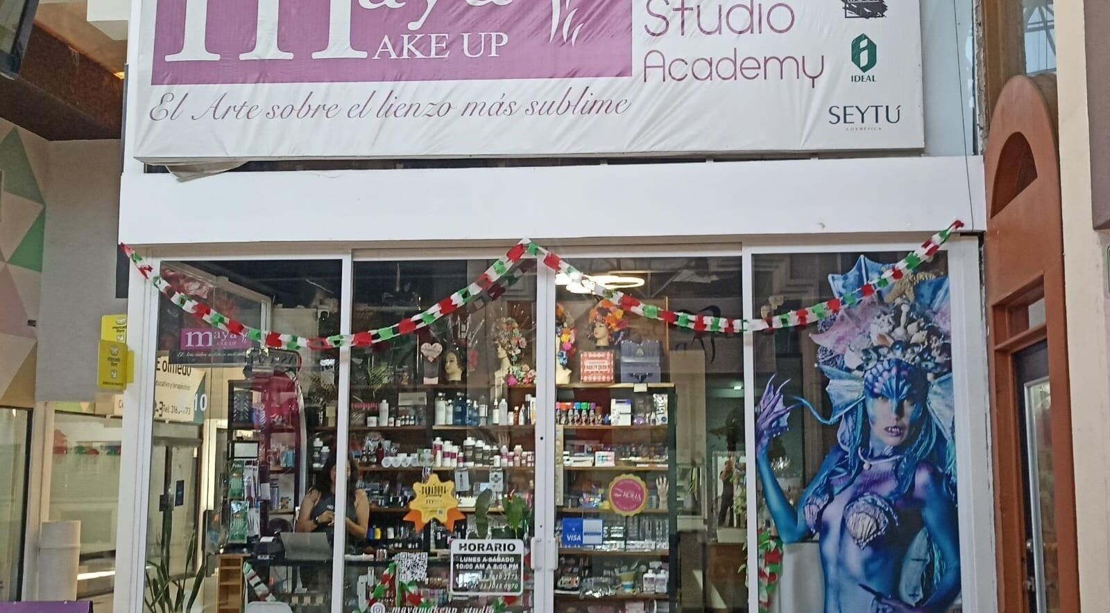 Entrance of Maya Make Up in Zapopan, Jalisco, MX, showcasing beauty products and festive decor.