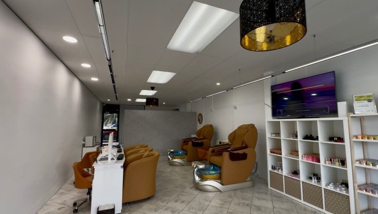 Interior of Eloura Nail in Plympton, South Australia, AU featuring modern pedicure chairs and polish display.