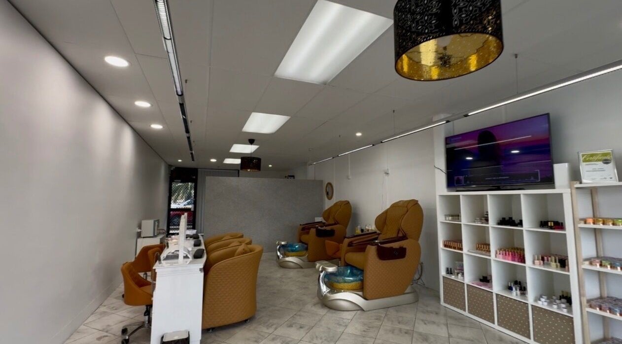 Interior of Eloura Nail in Plympton, South Australia, AU featuring modern pedicure chairs and polish display.