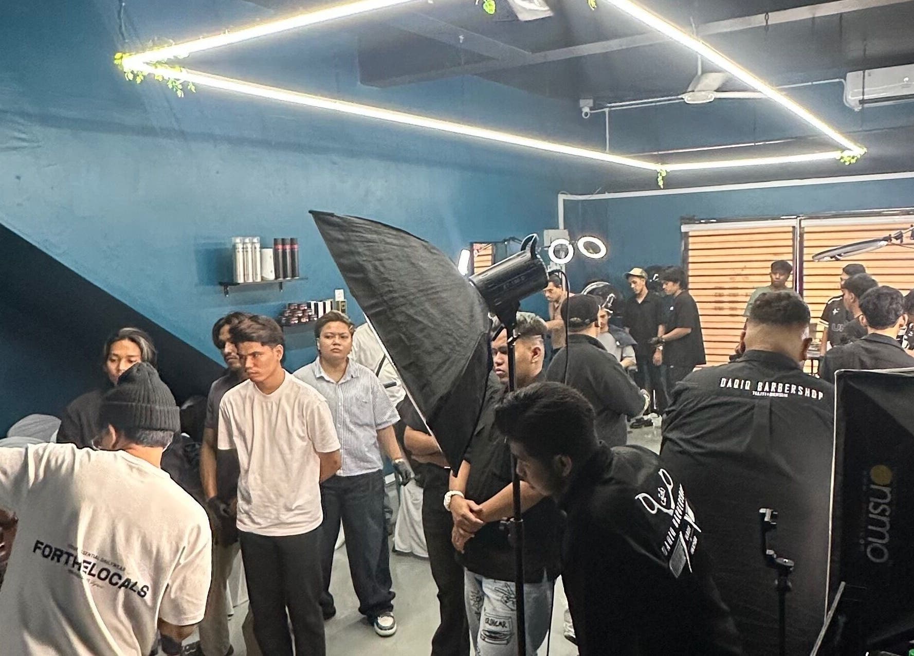 Daqiq Barbershop in Simpang Empat, Kedah, MY showcasing lively atmosphere with clients and barbers working.