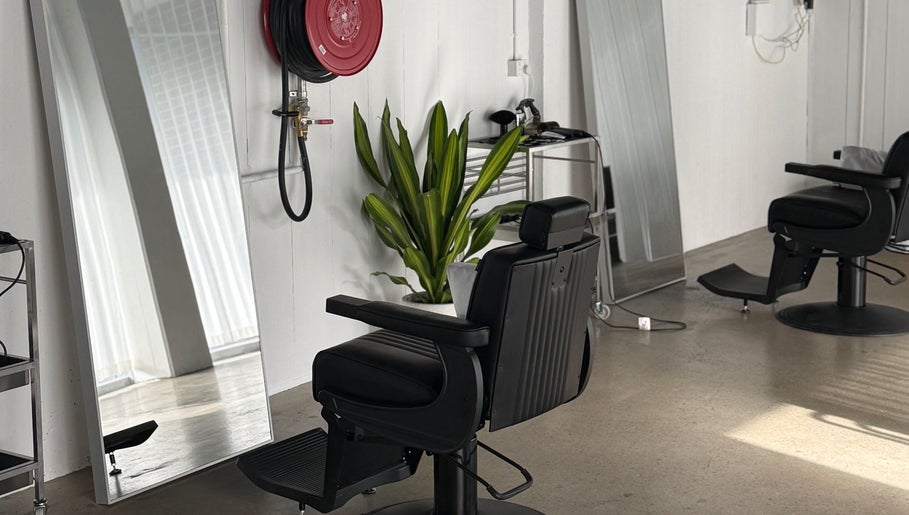 Sophisticated salon chair at STUDIO.M, Camperdown, New South Wales, AU, with modern décor and large mirrors.