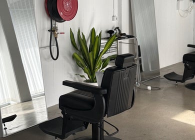 Sophisticated salon chair at STUDIO.M, Camperdown, New South Wales, AU, with modern décor and large mirrors.
