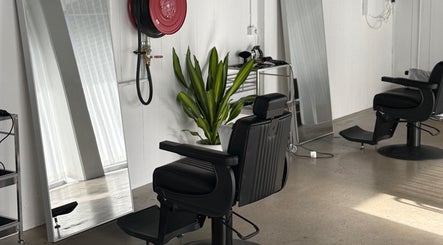 Sophisticated salon chair at STUDIO.M, Camperdown, New South Wales, AU, with modern décor and large mirrors.