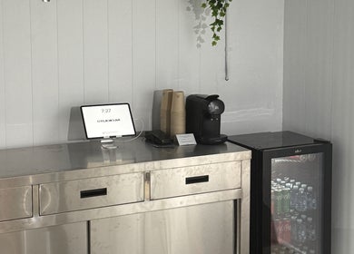 Refreshment area at STUDIO.M, Camperdown, New South Wales, AU, with drinks and a tablet.