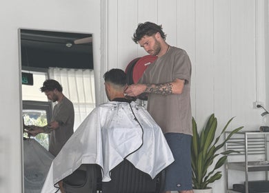 A hairstylist at STUDIO.M, Camperdown, New South Wales, AU, creating a fresh haircut for a client.