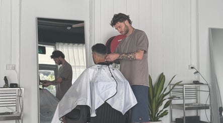 A hairstylist at STUDIO.M, Camperdown, New South Wales, AU, creating a fresh haircut for a client.
