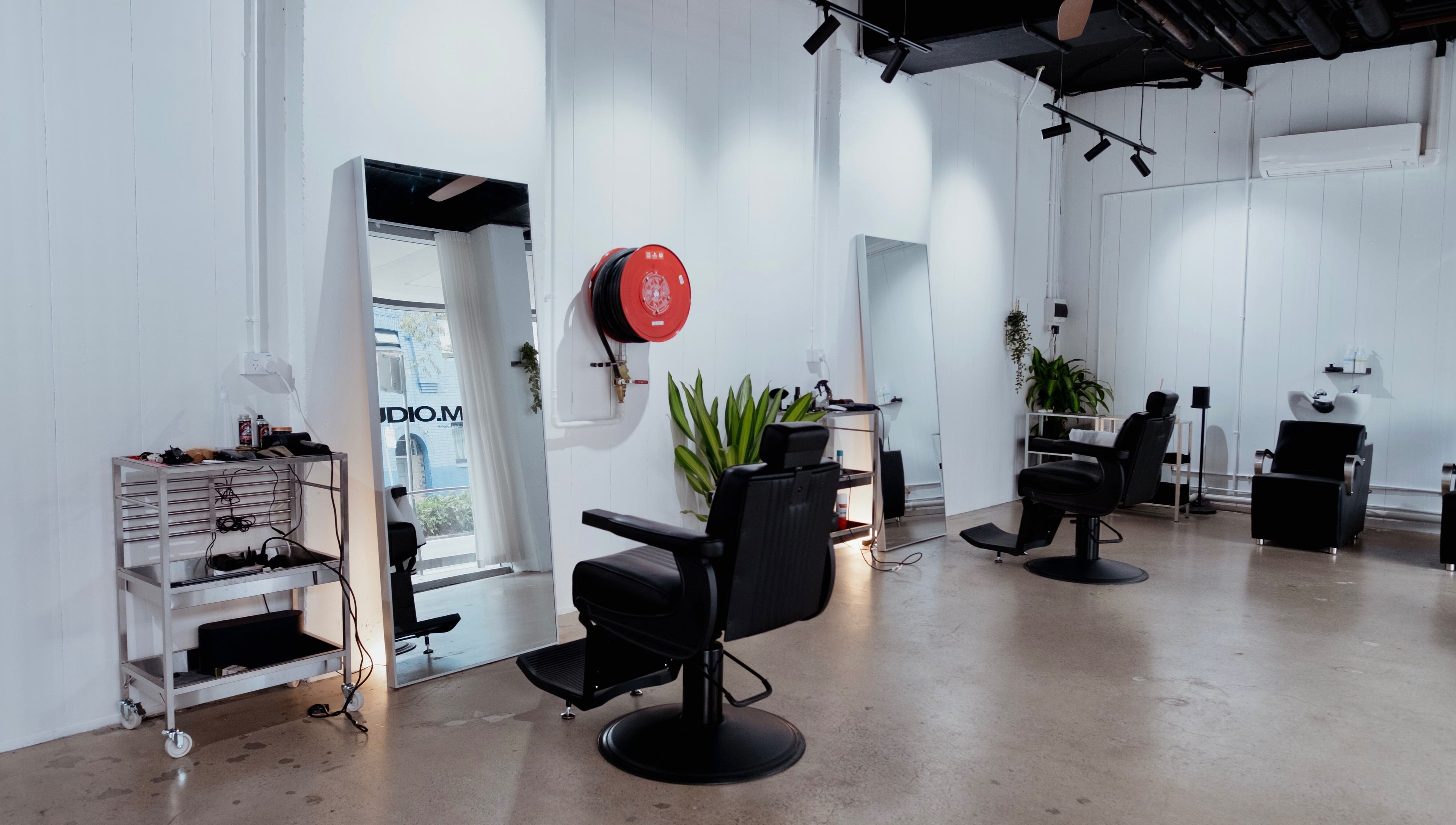 Modern interior at Studio.M, Camperdown, New South Wales, AU with sleek styling chairs and mirrors.
