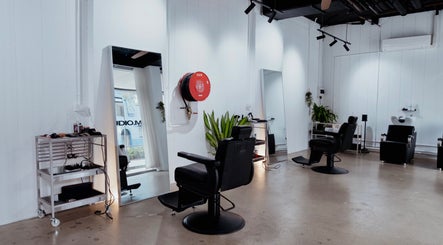Modern interior at Studio.M, Camperdown, New South Wales, AU with sleek styling chairs and mirrors.