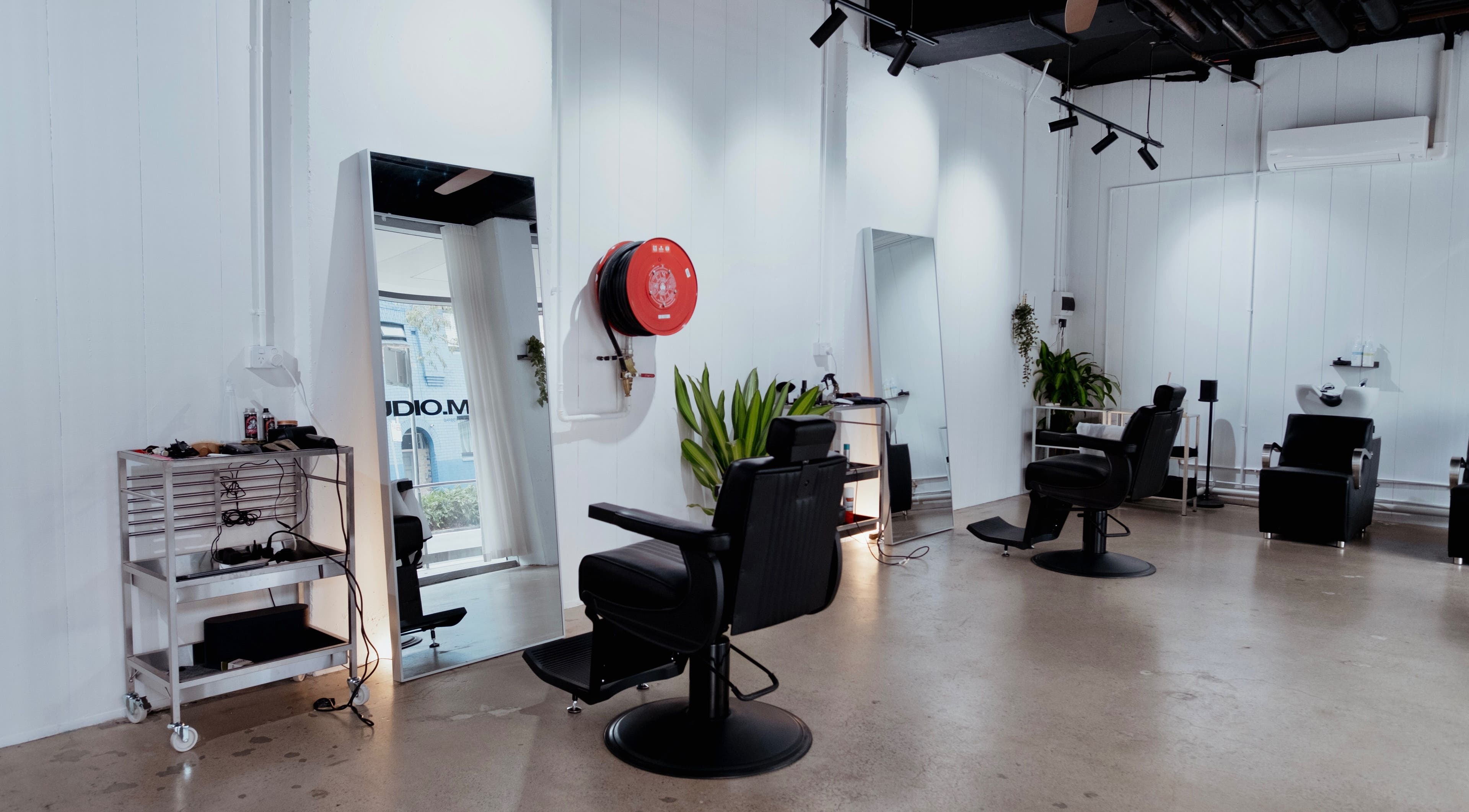 Modern interior at Studio.M, Camperdown, New South Wales, AU with sleek styling chairs and mirrors.