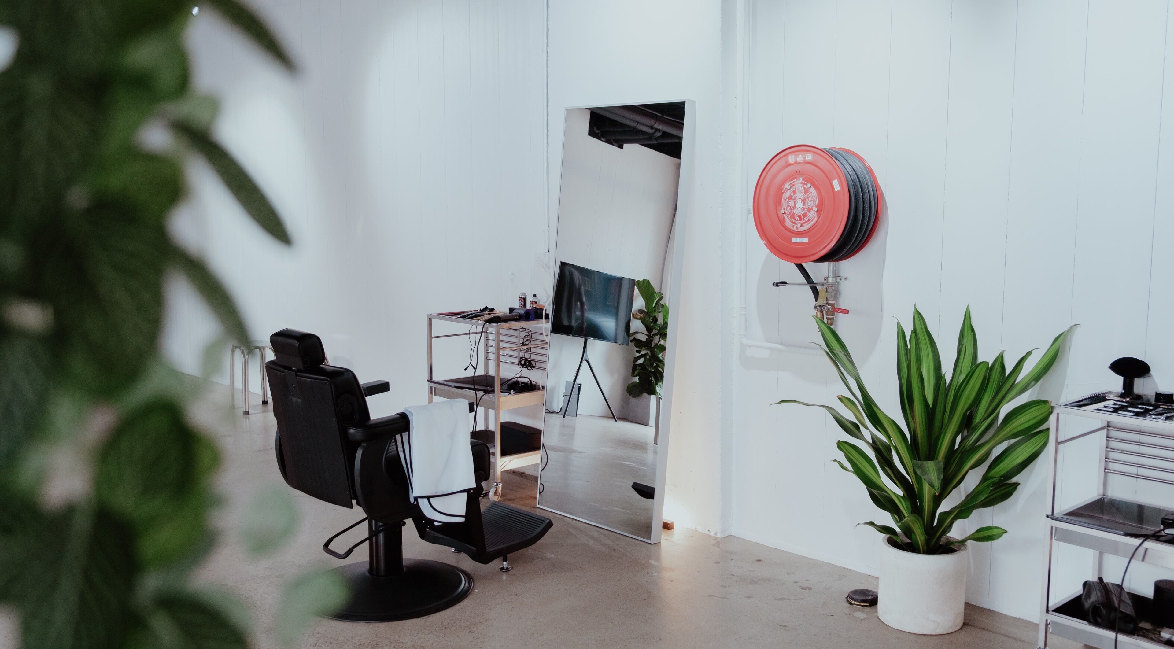 Modern salon interior at Studio.M, Camperdown, New South Wales, AU, featuring sleek styling chair and mirrors.