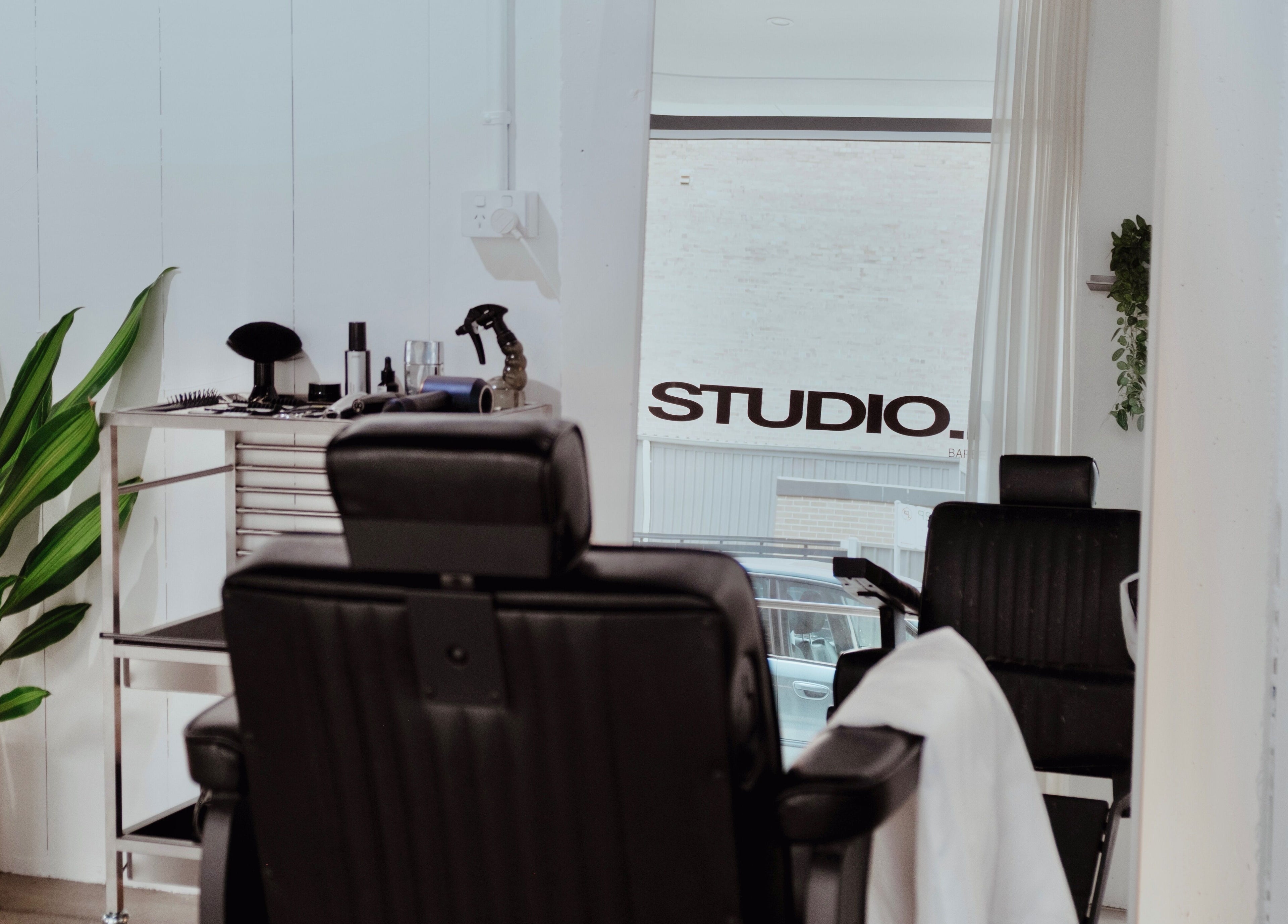 Elegant interior of STUDIO.M in Camperdown, New South Wales, AU with modern salon chairs and decor.
