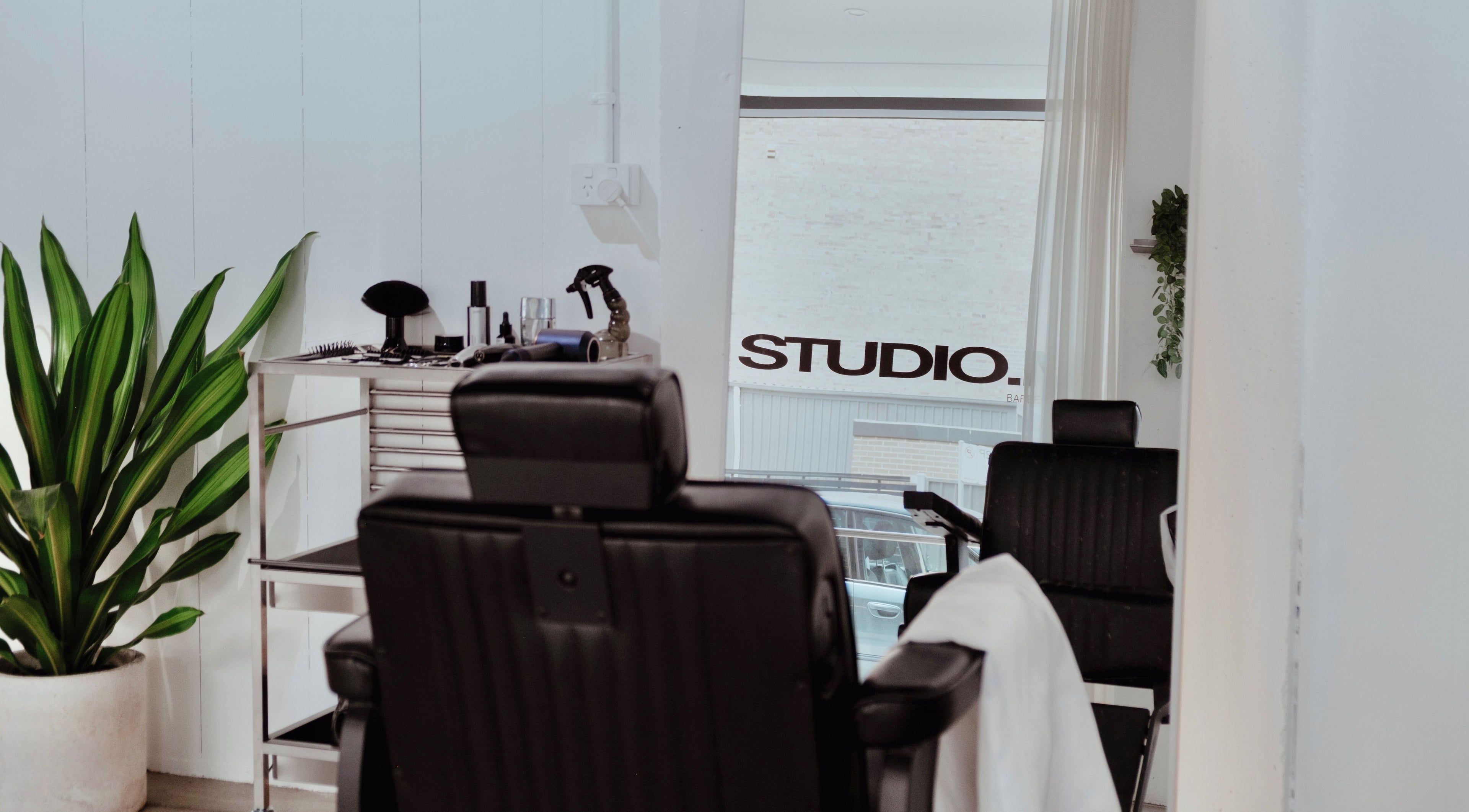 Elegant interior of STUDIO.M in Camperdown, New South Wales, AU with modern salon chairs and decor.