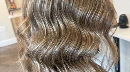 Golden wavy hair styled at Beau Hair, Gilberdyke, England, GB. Perfect for a chic and elegant look.