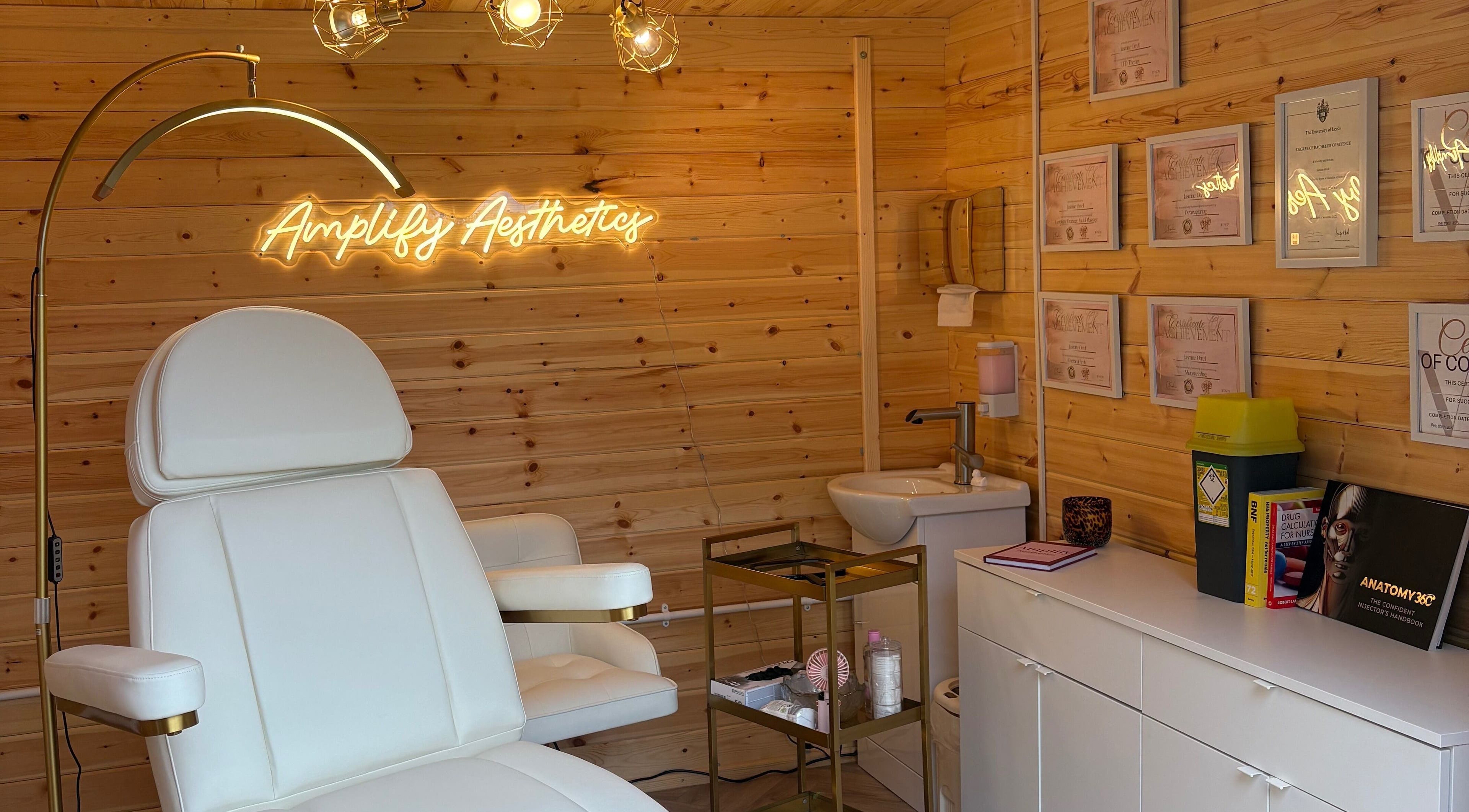 Elegant treatment room at Amplify Aesthetics in Addingham, England, GB, featuring a plush chair and modern decor.