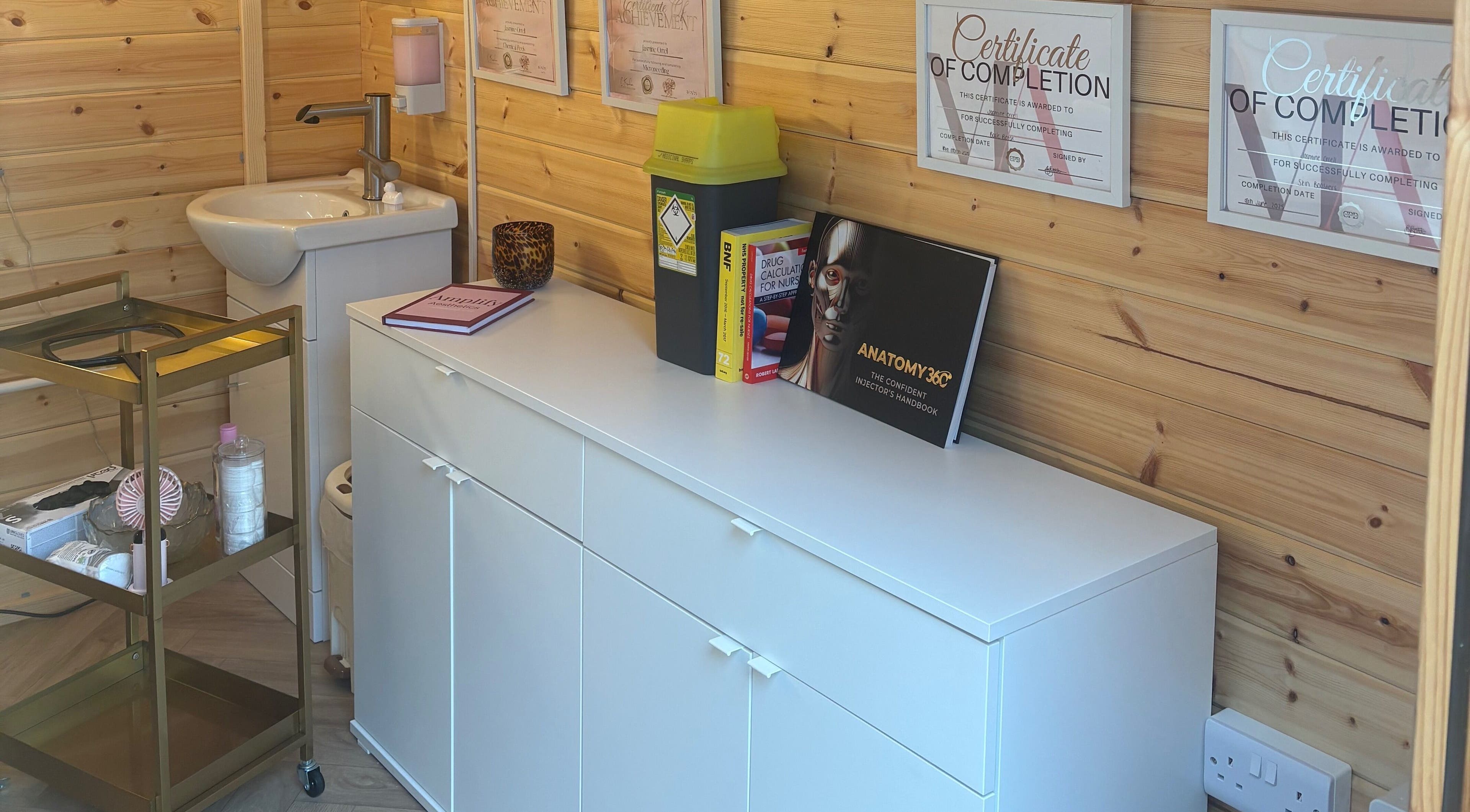 Amplify Aesthetics treatment room with certificates in Addingham, England, GB.