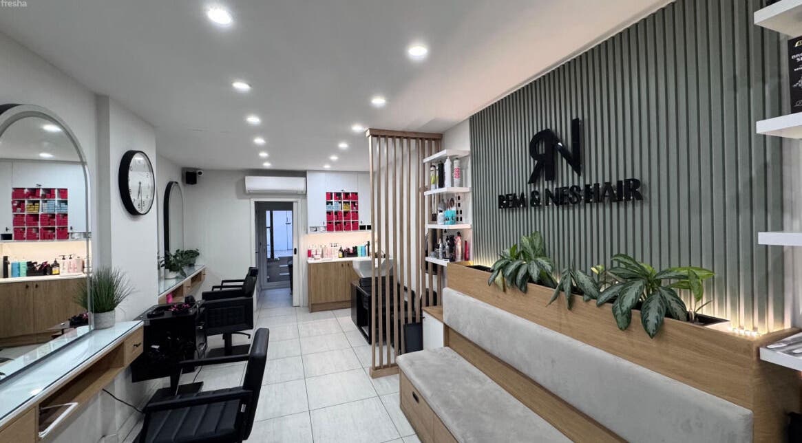 Modern hair salon interior at Rem and Nes, London, England, GB, showcasing stylish design and seating.