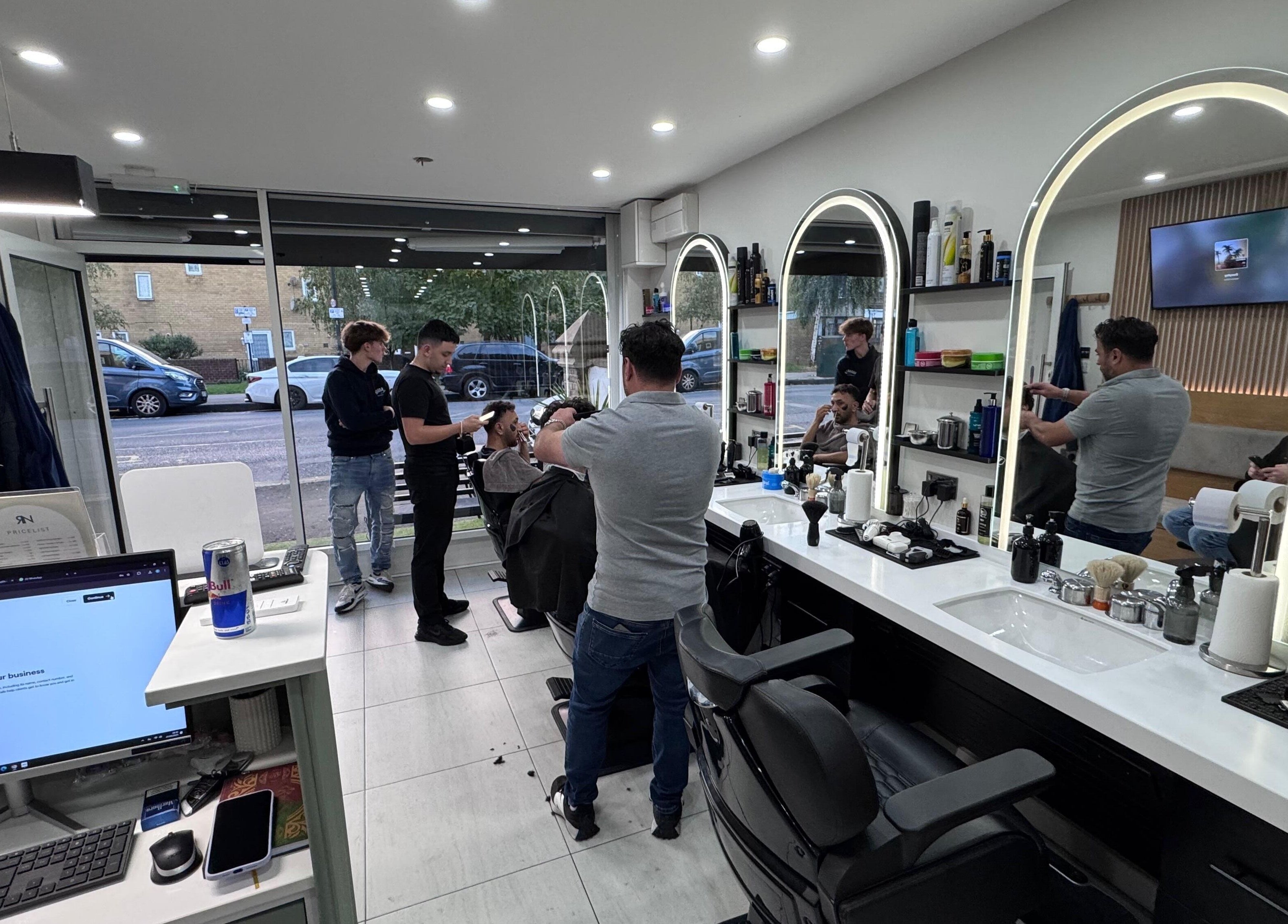 Inside Rem and Nes, a modern salon in London, England, GB showcasing stylists with clients at mirrors.