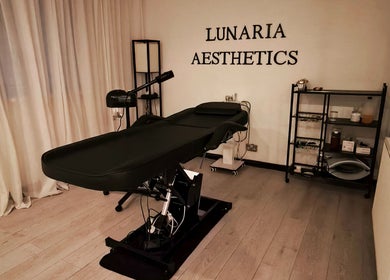 Relaxing treatment room at Lunaria Aesthetics, Nazeing, England, GB, featuring an elegant black treatment table.