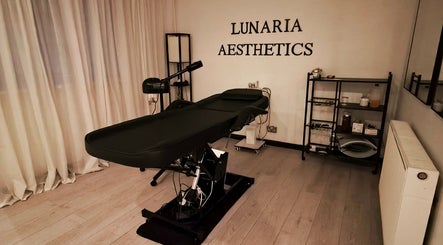 Relaxing treatment room at Lunaria Aesthetics, Nazeing, England, GB, featuring an elegant black treatment table.