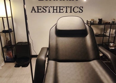 Elegant treatment room at Lunaria Aesthetics, Nazeing, England, GB, featuring a sleek black chair and calming decor.