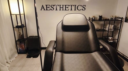 Elegant treatment room at Lunaria Aesthetics, Nazeing, England, GB, featuring a sleek black chair and calming decor.