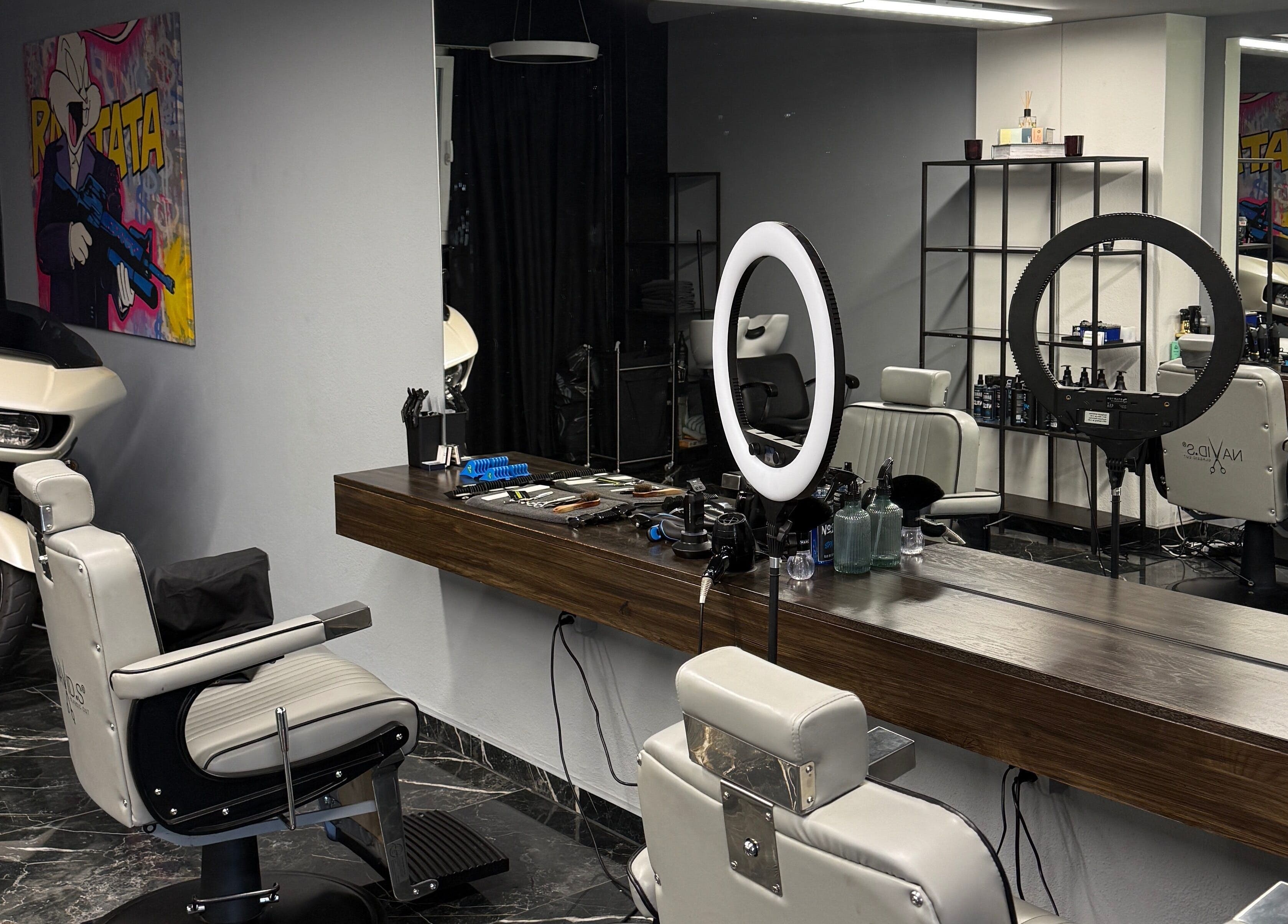 Modern barbershop interior at mmpcutz, Uster, Zürich, CH with white chairs and sleek design.