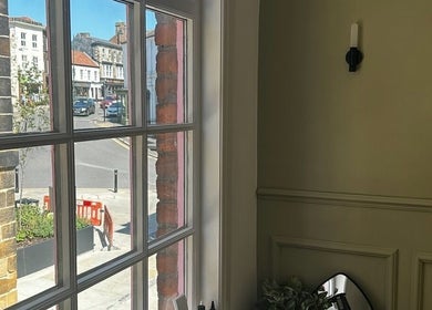 View from ARCHE's window showcasing the charming street of Guisborough, England, GB under clear skies.
