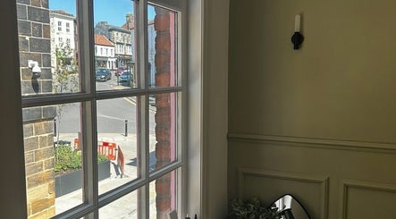 View from ARCHE's window showcasing the charming street of Guisborough, England, GB under clear skies.
