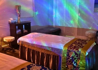 Relaxing massage room at A Magic Massage INC in Winter Park, Florida with soft lighting and luxurious decor.