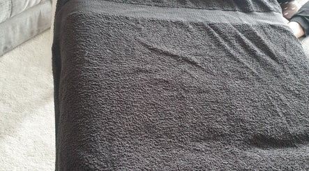 A comfortable massage table with a dark towel at Knotts Massage, Nottingham, England, GB.