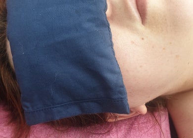 Person relaxing with eye mask at Knotts Massage, Nottingham, England, GB for ultimate wellness experience.